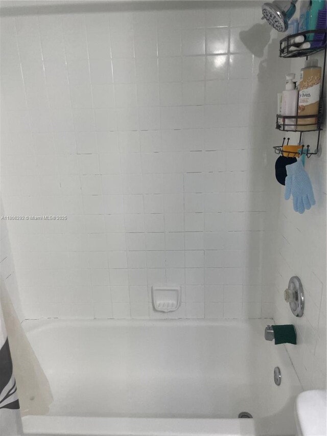 5200 NW 31st Ave Unit 102, Fort Lauderdale, FL 33309 - bathroom featuring shower / bath combo with shower curtain and toilet