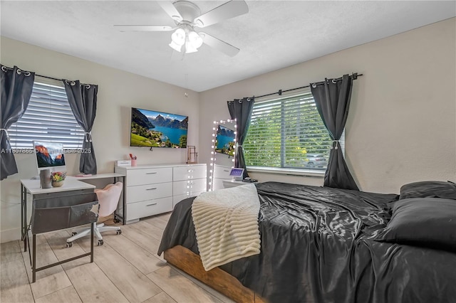 2161 SW 87th Ct, Miami, FL 33165 - bedroom with an office area, a ceiling fan, and light wood-style flooring