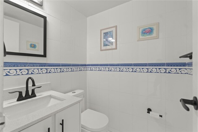 6969 Collins Ave Unit 707, Miami Beach, FL 33141 - bathroom featuring toilet, tile walls, and vanity