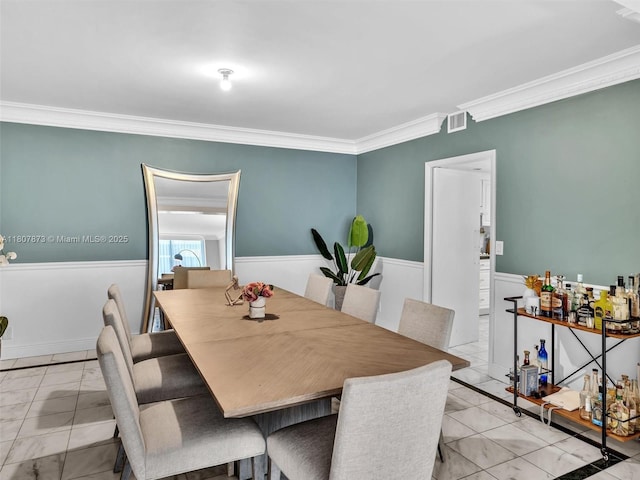 10155 Collins Ave Unit 408, Bal Harbour, FL 33154 - dining space featuring light marble finish floors, ornamental molding, and wainscoting