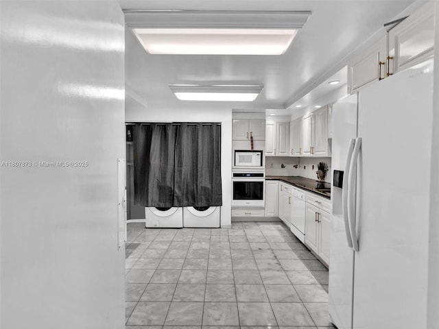 10155 Collins Ave Unit 408, Bal Harbour, FL 33154 - kitchen with white appliances, white cabinets, and dark countertops