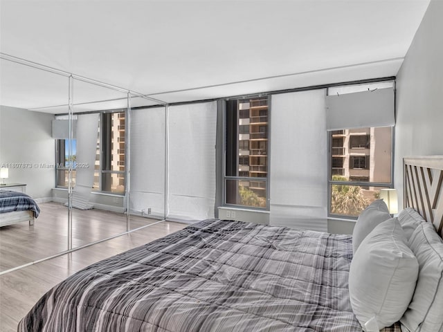10155 Collins Ave Unit 408, Bal Harbour, FL 33154 - bedroom featuring wood finished floors and baseboards