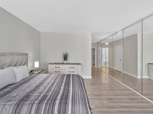 10155 Collins Ave Unit 408, Bal Harbour, FL 33154 - bedroom with wood finished floors and a closet