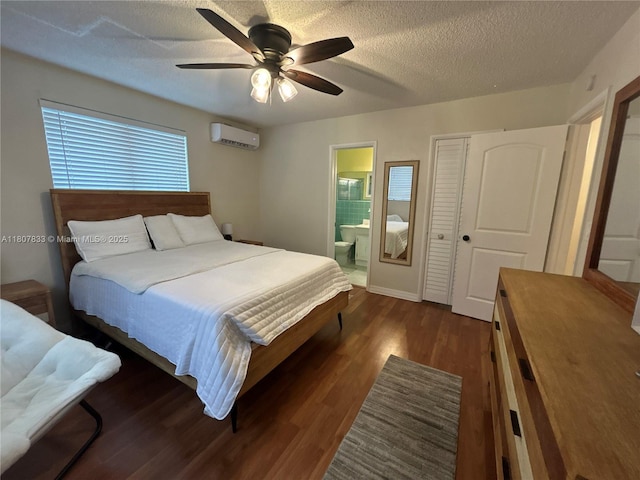 1717 Rodman St Unit 18, Hollywood, FL 33020 - bedroom featuring a wall mounted AC, dark wood-style flooring, ensuite bathroom, ceiling fan, and a textured ceiling