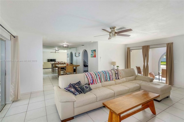 2001 NW 93rd Ln, Sunrise, FL 33322 - living room featuring arched walkways, light tile patterned flooring, and ceiling fan