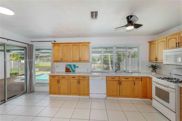 2001 NW 93rd Ln, Sunrise, FL 33322 - kitchen with white appliances, a sink, light countertops, decorative backsplash, and healthy amount of natural light