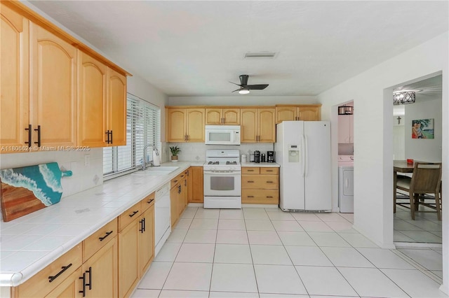 2001 NW 93rd Ln, Sunrise, FL 33322 - kitchen featuring white appliances, a sink, washer / clothes dryer, and light brown cabinets