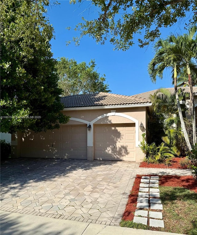 3700 Oak Ridge Ln, Weston, FL 33331 - view of front of property featuring stucco siding, a tiled roof, and driveway