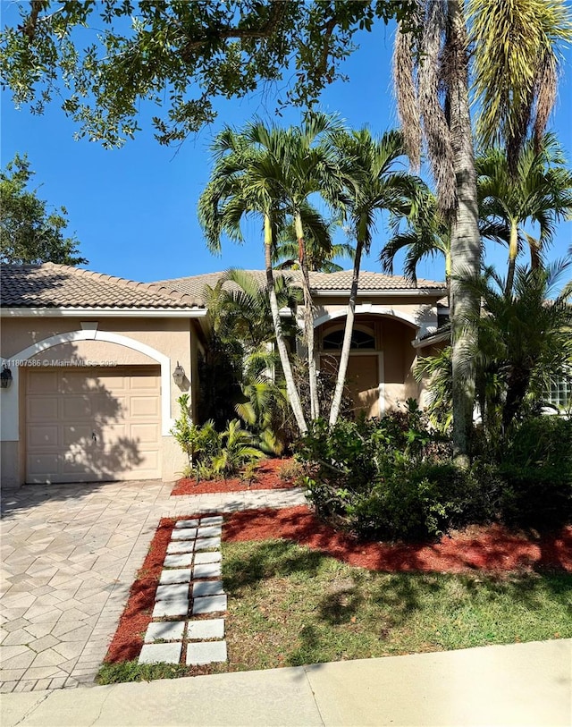 3700 Oak Ridge Ln, Weston, FL 33331 - view of front of home featuring a tile roof, driveway, a garage, and stucco siding