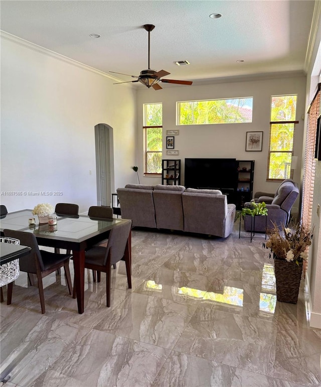 3700 Oak Ridge Ln, Weston, FL 33331 - dining space featuring crown molding, ceiling fan, light marble finish flooring, and arched walkways