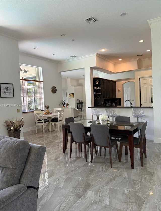3700 Oak Ridge Ln, Weston, FL 33331 - dining area featuring ornamental molding, baseboards, arched walkways, and recessed lighting