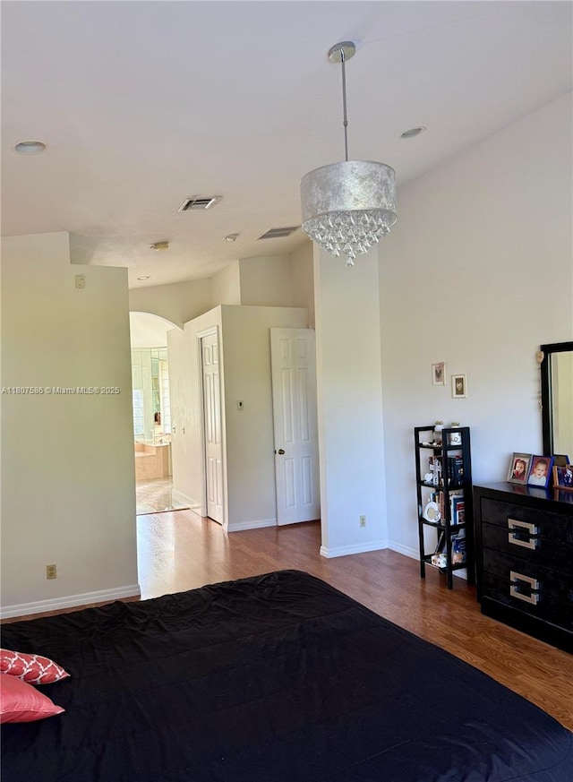 3700 Oak Ridge Ln, Weston, FL 33331 - bedroom featuring wood finished floors, arched walkways, and baseboards