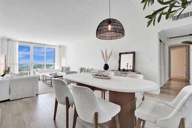 19380 Collins Ave Unit 718, Sunny Isles Beach, FL 33160 - dining area featuring light wood-style flooring and expansive windows