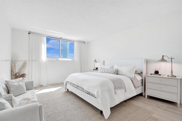 19380 Collins Ave Unit 718, Sunny Isles Beach, FL 33160 - bedroom with light wood-style flooring and a textured ceiling