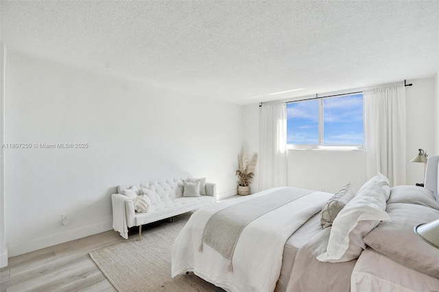 19380 Collins Ave Unit 718, Sunny Isles Beach, FL 33160 - bedroom with wood finished floors, a textured ceiling, and baseboards
