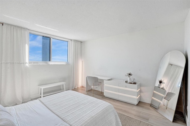 19380 Collins Ave Unit 718, Sunny Isles Beach, FL 33160 - bedroom featuring light wood-style floors and a textured ceiling