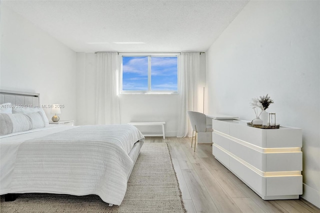 19380 Collins Ave Unit 718, Sunny Isles Beach, FL 33160 - bedroom with light wood-type flooring and a textured ceiling