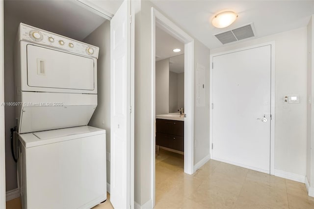 1755 E Hallandale Beach Blvd Unit 1604E, Hallandale Beach, FL 33009 - washroom featuring stacked washer / dryer and baseboards