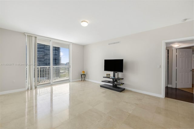 1755 E Hallandale Beach Blvd Unit 1604E, Hallandale Beach, FL 33009 - unfurnished living room featuring baseboards, floor to ceiling windows, and tile patterned flooring