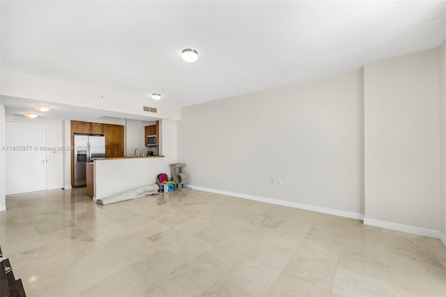 1755 E Hallandale Beach Blvd Unit 1604E, Hallandale Beach, FL 33009 - unfurnished living room with baseboards and a sink
