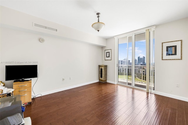 1755 E Hallandale Beach Blvd Unit 1604E, Hallandale Beach, FL 33009 - unfurnished living room with a wall of windows, baseboards, wood finished floors, and a skyline view