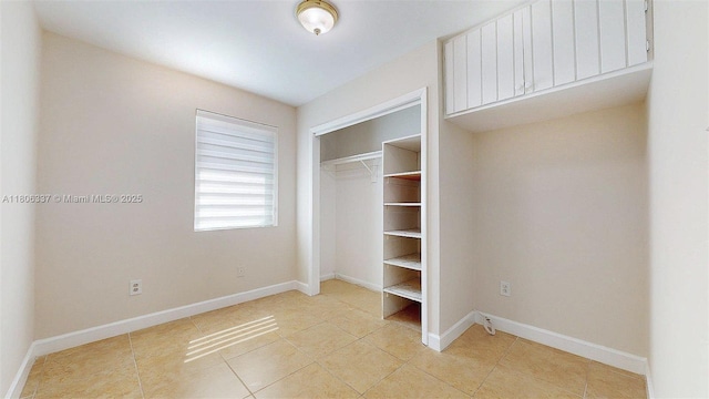 5301 SW 111th Ave, Miami, FL 33165 - unfurnished bedroom with light tile patterned floors, a closet, and baseboards
