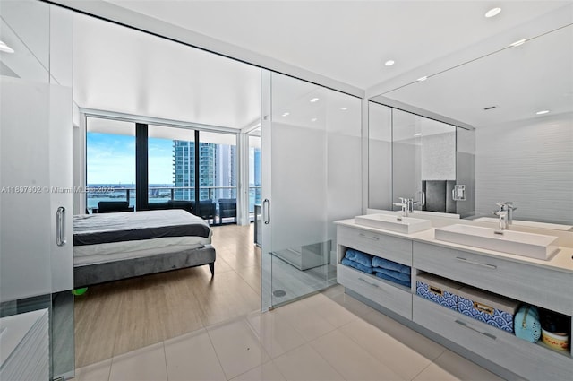 650 NE 32nd St Unit 4101, Miami, FL 33137 - full bathroom with floor to ceiling windows, ensuite bathroom, double vanity, a stall shower, and tile patterned flooring
