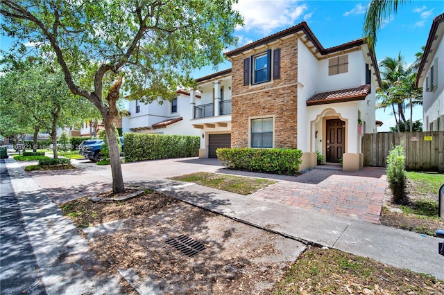 557 SE 37th Pl, Homestead, FL 33033 - view of front of home with a tile roof, a garage, a balcony, stucco siding, and concrete driveway