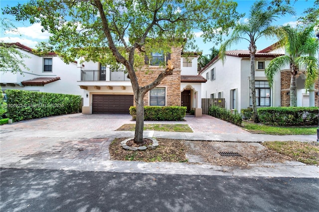 557 SE 37th Pl, Homestead, FL 33033 - view of front of house featuring a tiled roof, stucco siding, a balcony, driveway, and a garage