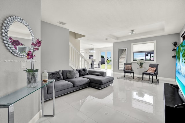 557 SE 37th Pl, Homestead, FL 33033 - living area with stairway, baseboards, light tile patterned floors, and a tray ceiling