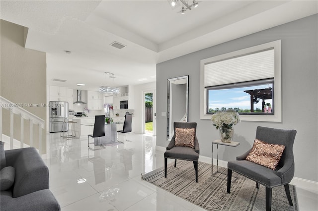 557 SE 37th Pl, Homestead, FL 33033 - living area with baseboards and a chandelier