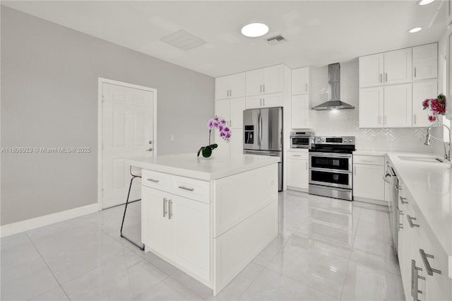 557 SE 37th Pl, Homestead, FL 33033 - kitchen featuring appliances with stainless steel finishes, wall chimney exhaust hood, a sink, decorative backsplash, and light countertops