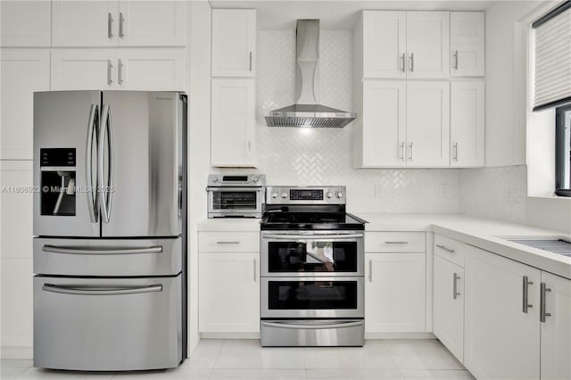 557 SE 37th Pl, Homestead, FL 33033 - kitchen featuring stainless steel appliances, wall chimney exhaust hood, white cabinets, and light countertops