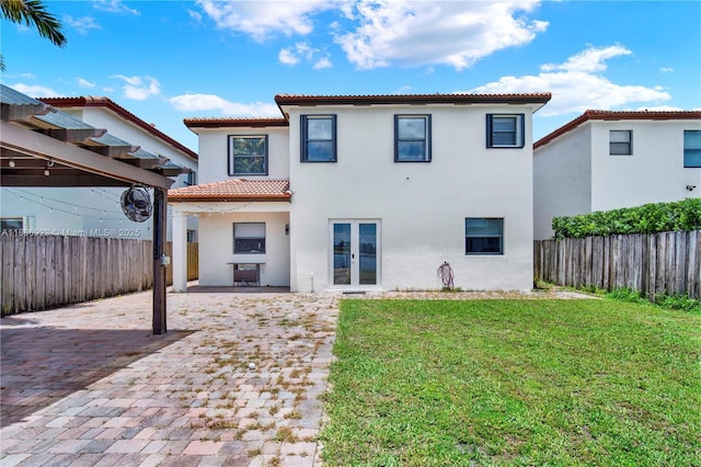 557 SE 37th Pl, Homestead, FL 33033 - back of property featuring a tiled roof, french doors, stucco siding, and a patio