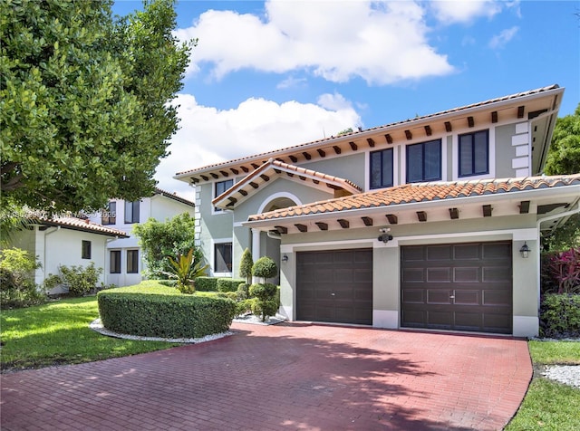 7582 SW 191st St, Cutler Bay, FL 33157 - mediterranean / spanish-style home featuring decorative driveway, stucco siding, a tiled roof, and a garage
