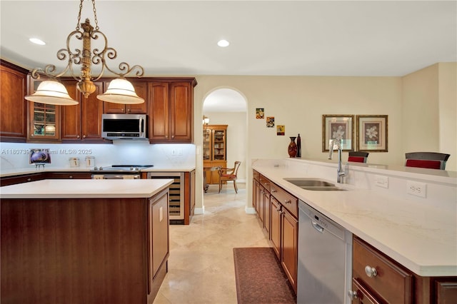 7582 SW 191st St, Cutler Bay, FL 33157 - kitchen with appliances with stainless steel finishes, a sink, arched walkways, light countertops, and recessed lighting