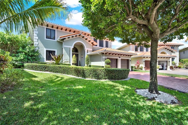 7582 SW 191st St, Cutler Bay, FL 33157 - mediterranean / spanish house with stucco siding, decorative driveway, a front lawn, and a tiled roof