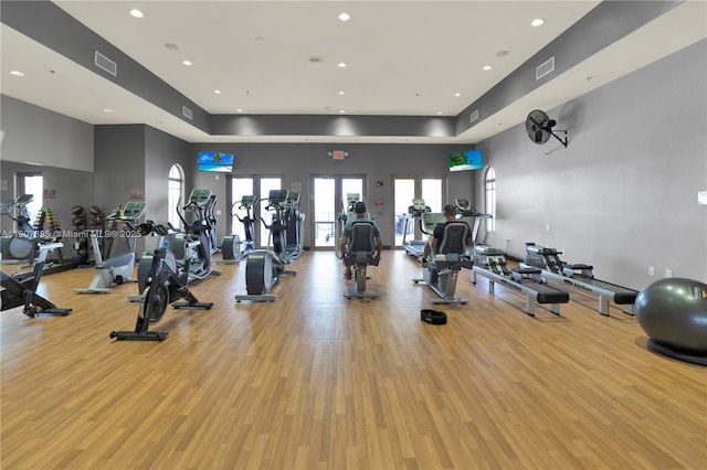 7582 SW 191st St, Cutler Bay, FL 33157 - exercise room featuring wood finished floors, a tray ceiling, and recessed lighting