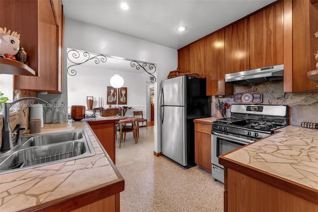 1895 SW 25th St, Miami, FL 33133 - kitchen with under cabinet range hood, appliances with stainless steel finishes, a sink, brown cabinets, and recessed lighting