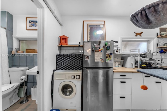 1895 SW 25th St, Miami, FL 33133 - washroom featuring washer / clothes dryer and tile patterned flooring