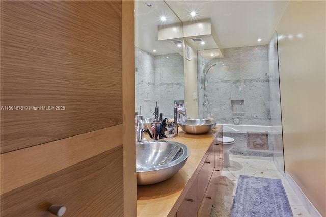5005 Collins Ave Unit 212, Miami Beach, FL 33140 - full bath with toilet, double vanity, recessed lighting, and a combined bath / shower with marble appearance