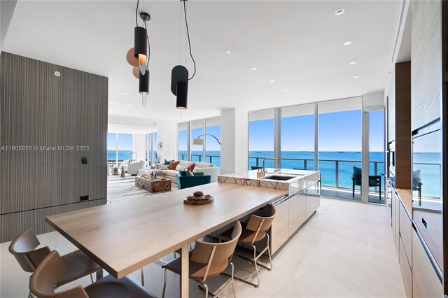 2200 N Ocean Blvd Unit N1102, Fort Lauderdale, FL 33305 - kitchen with modern cabinets, a sink, expansive windows, a water view, and pendant lighting