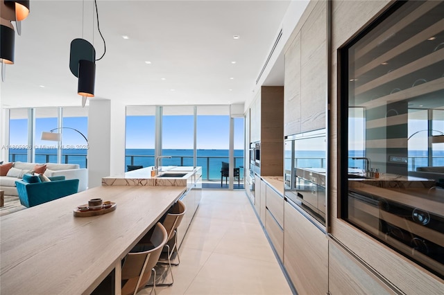 2200 N Ocean Blvd Unit N1102, Fort Lauderdale, FL 33305 - kitchen featuring modern cabinets, a wall of windows, a sink, a water view, and open floor plan