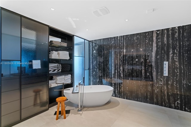 2200 N Ocean Blvd Unit N1102, Fort Lauderdale, FL 33305 - bathroom with a freestanding tub, a wall of windows, and tile patterned flooring