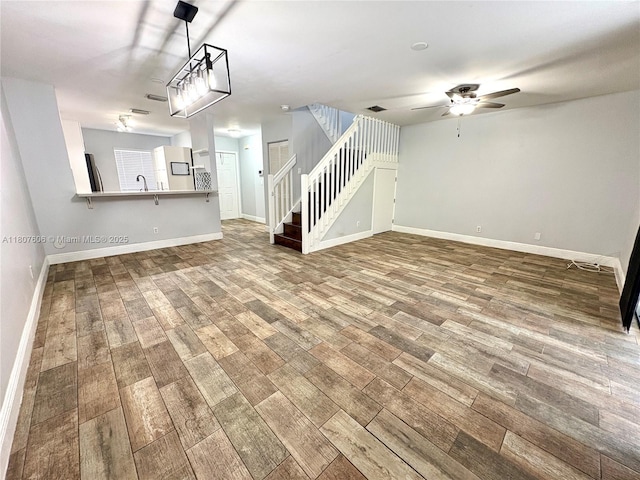 20866 NW 3rd Ln, Pembroke Pines, FL 33029 - unfurnished living room featuring a ceiling fan, wood finished floors, and stairs