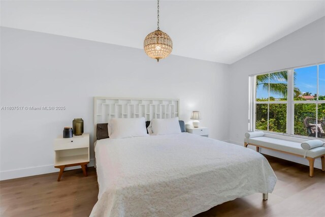 18501 NW 19th St, Pembroke Pines, FL 33029 - bedroom featuring lofted ceiling, wood finished floors, a chandelier, and baseboards