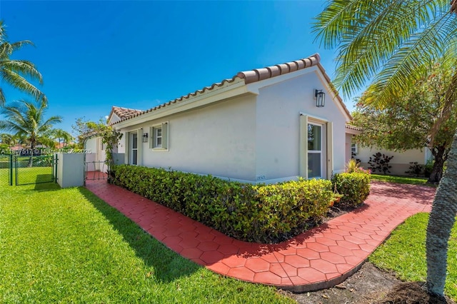 18501 NW 19th St, Pembroke Pines, FL 33029 - view of property exterior featuring a gate, stucco siding, and a tiled roof
