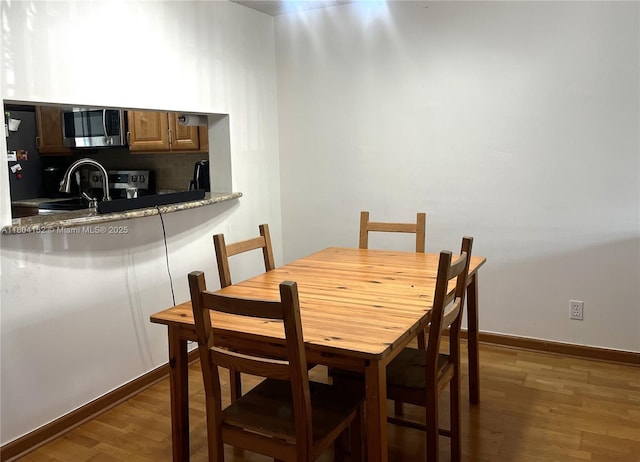 9955 NW 56th Pl, Coral Springs, FL 33076 - dining area with wood finished floors and baseboards