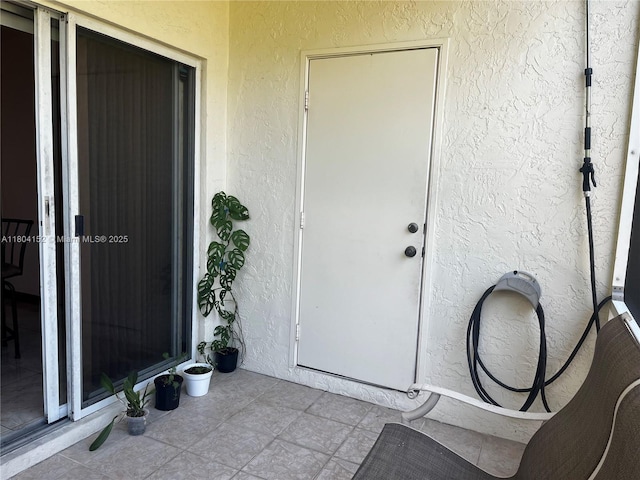 9955 NW 56th Pl, Coral Springs, FL 33076 - doorway to property with stucco siding