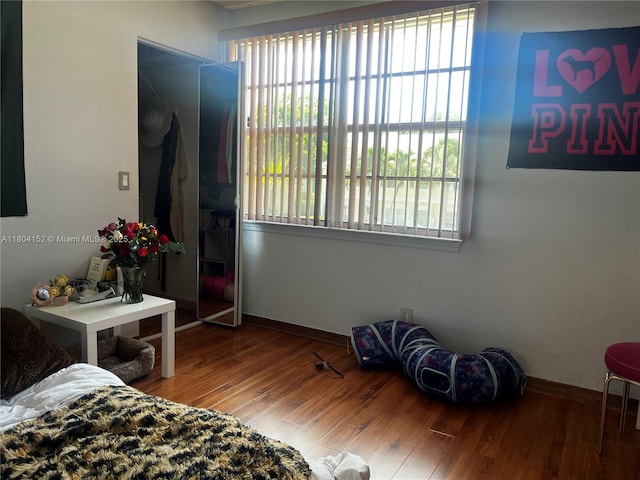 9955 NW 56th Pl, Coral Springs, FL 33076 - bedroom with multiple windows, baseboards, and wood finished floors